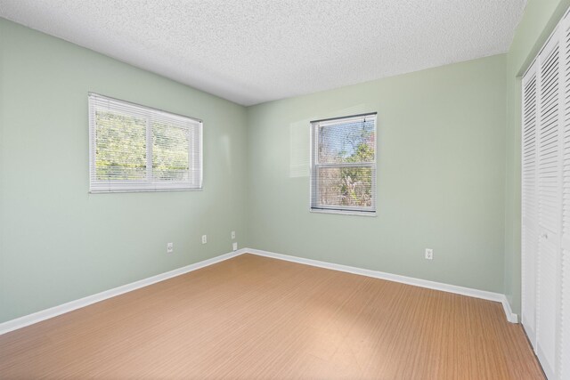 422 Nervia Ct, Saint Augustine, FL 32086 - spare room with a textured ceiling, wood finished floors, and baseboards