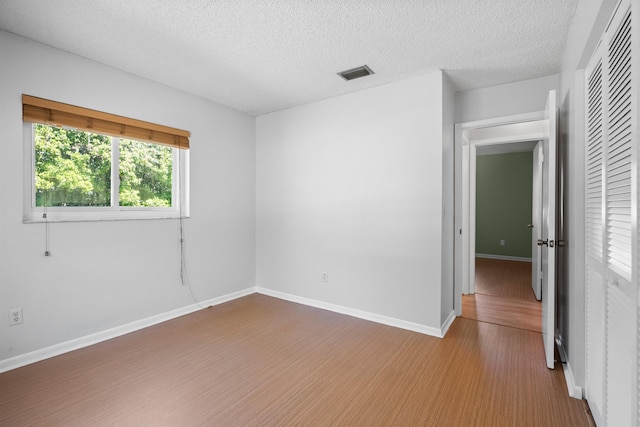 422 Nervia Ct, Saint Augustine, FL 32086 - unfurnished room with baseboards, a textured ceiling, visible vents, and wood finished floors