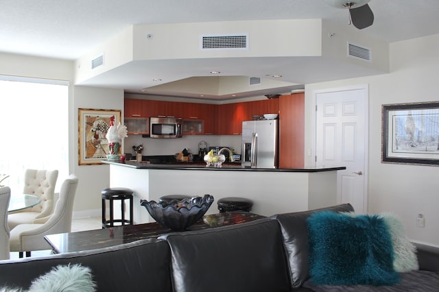 kitchen with kitchen peninsula and appliances with stainless steel finishes