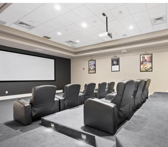 cinema with carpet floors and a paneled ceiling