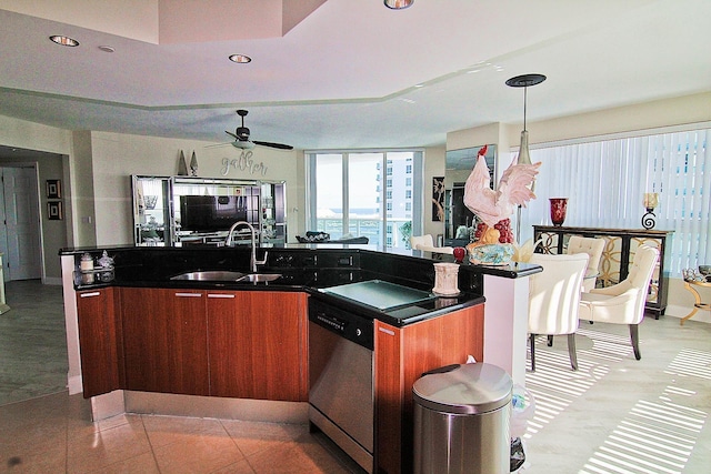 kitchen featuring light tile patterned flooring, sink, dishwasher, an island with sink, and pendant lighting