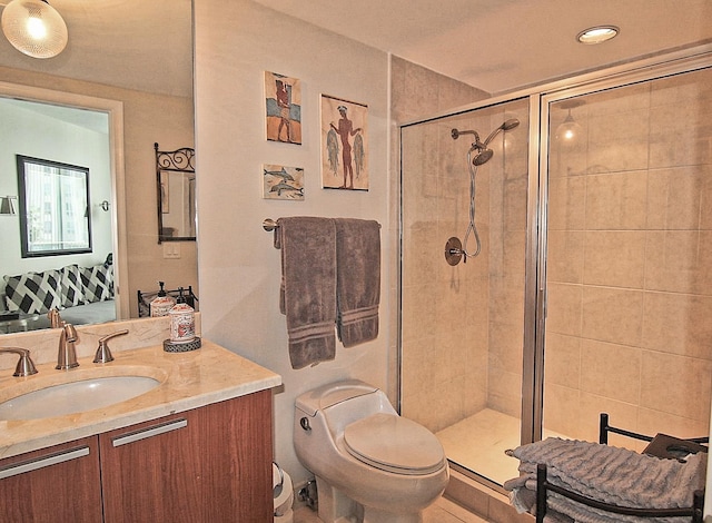 bathroom with an enclosed shower, vanity, and toilet