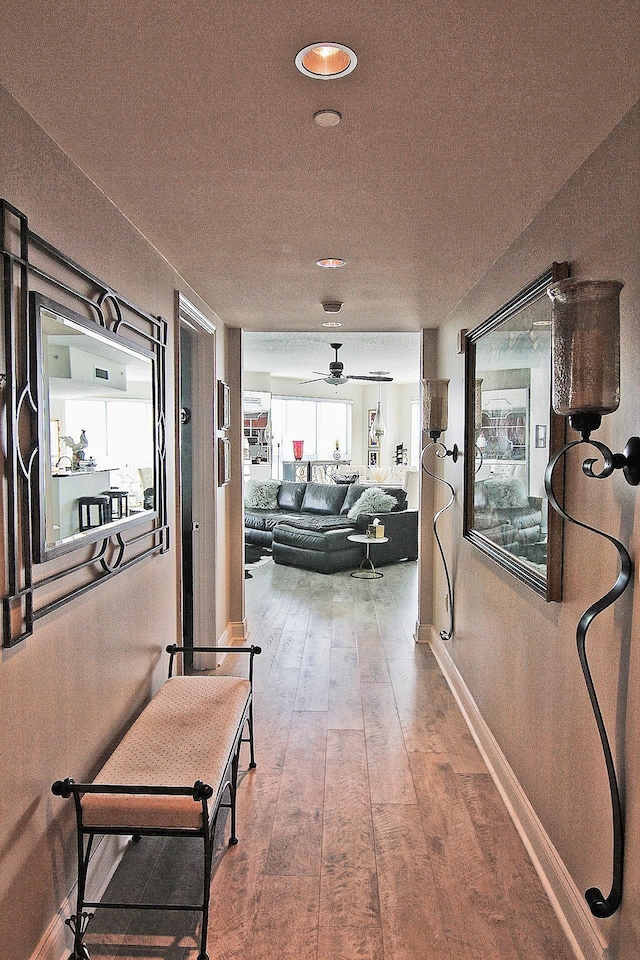 hallway with wood-type flooring