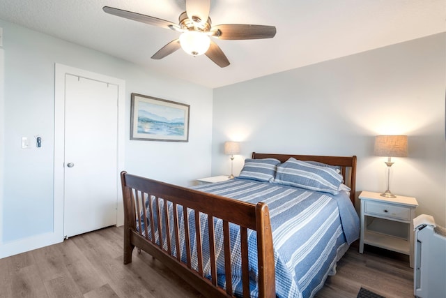 bedroom with ceiling fan and light hardwood / wood-style floors