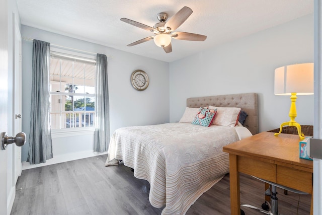 bedroom featuring hardwood / wood-style flooring and ceiling fan