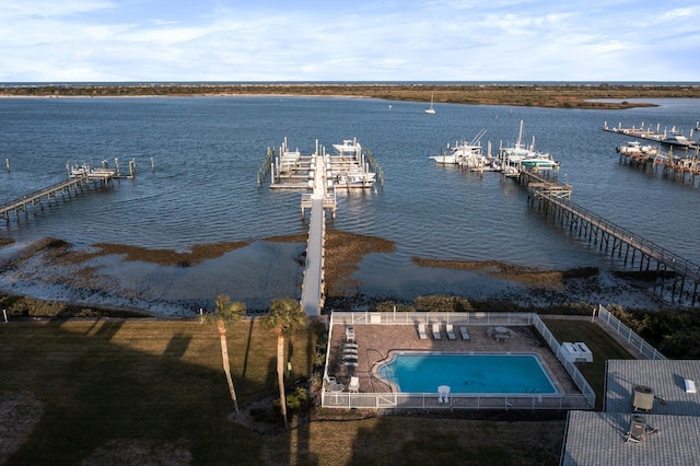 dock area featuring a water view and a community pool