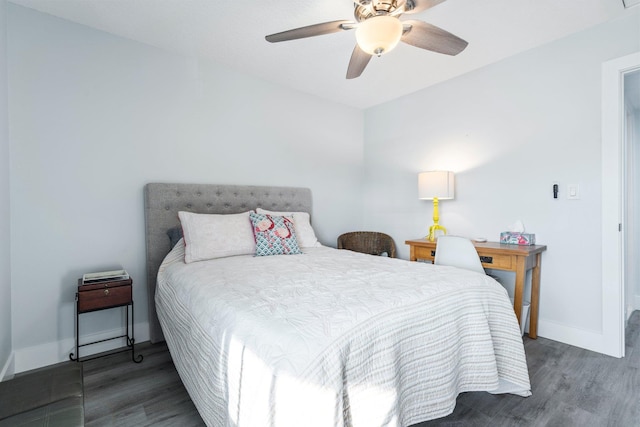 bedroom with dark hardwood / wood-style floors and ceiling fan