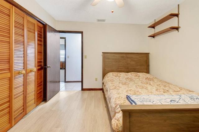 bedroom with ceiling fan, a closet, and light wood-type flooring