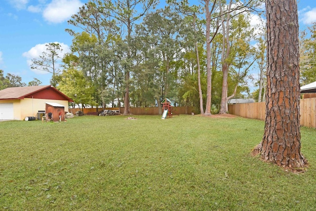 view of yard featuring a storage unit and a playground