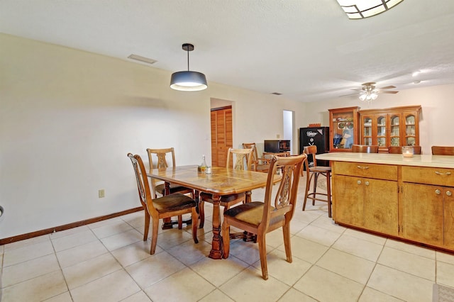 dining area with light tile patterned floors and ceiling fan