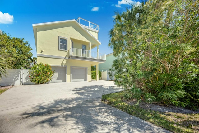 view of front of house featuring a balcony and a garage