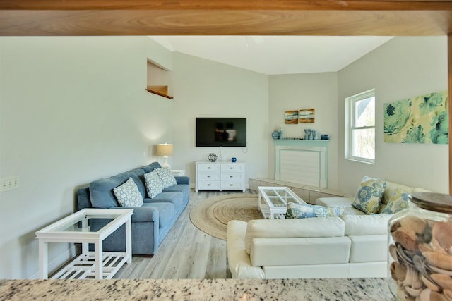 living room featuring light wood-type flooring and lofted ceiling