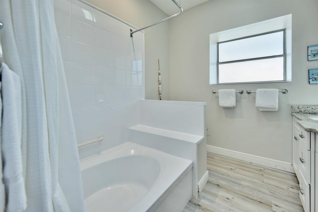 bathroom featuring hardwood / wood-style floors, vanity, and shower / bath combo with shower curtain