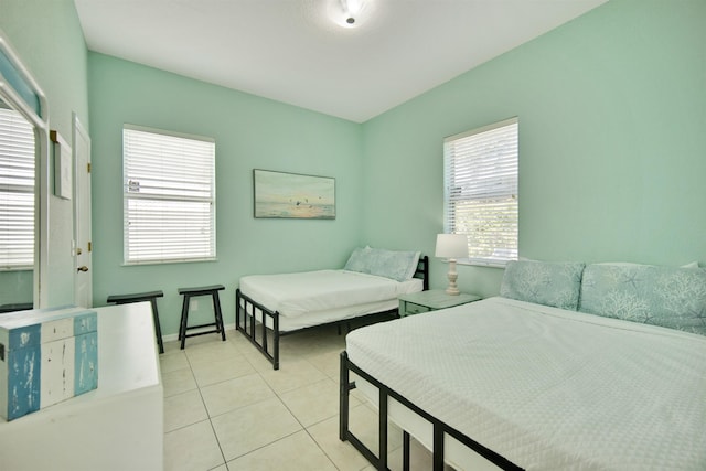 tiled bedroom featuring multiple windows