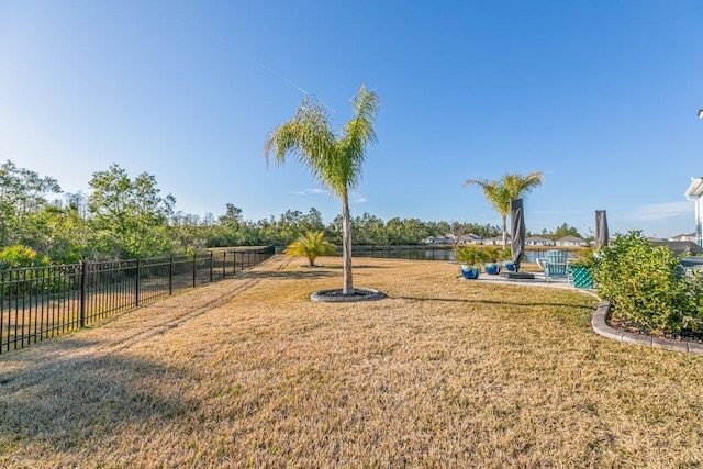 view of yard featuring a water view and a patio area