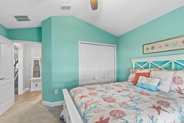 carpeted bedroom with lofted ceiling, a closet, and ceiling fan