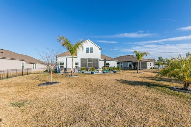 back of house featuring a yard