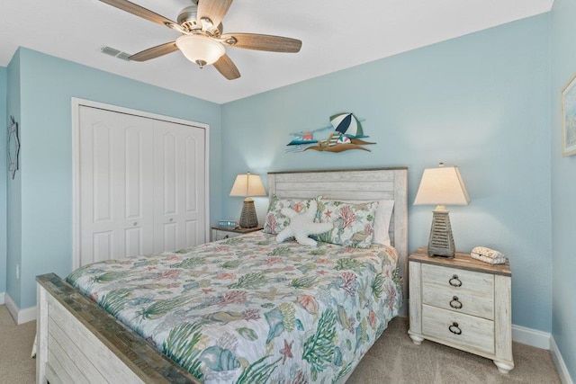 bedroom featuring light colored carpet, ceiling fan, and a closet