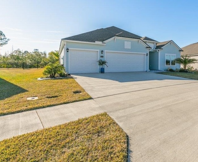 view of front facade with a garage and a front yard