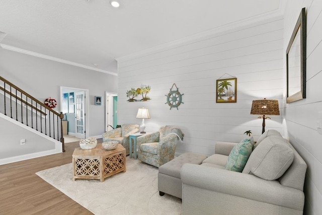 living room featuring wood-type flooring and ornamental molding