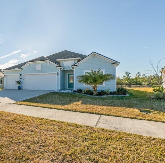 view of front of property with a garage and a front lawn