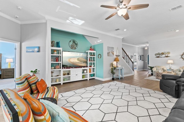 living room featuring hardwood / wood-style floors, ornamental molding, and ceiling fan