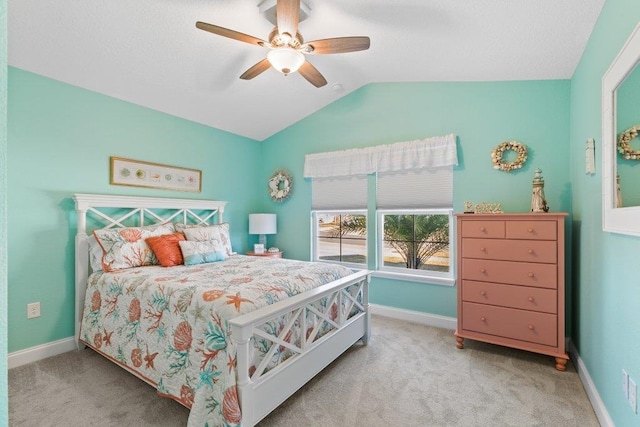 bedroom with vaulted ceiling, light colored carpet, and ceiling fan