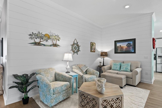 living room featuring wood-type flooring and ornamental molding