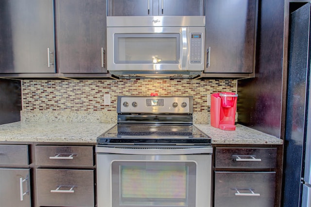 kitchen featuring light stone counters, dark brown cabinetry, stainless steel appliances, and tasteful backsplash