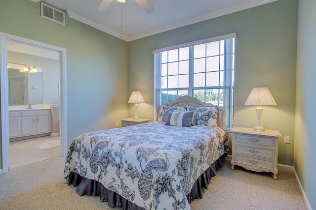 bedroom featuring light carpet, sink, ornamental molding, ceiling fan, and ensuite bathroom