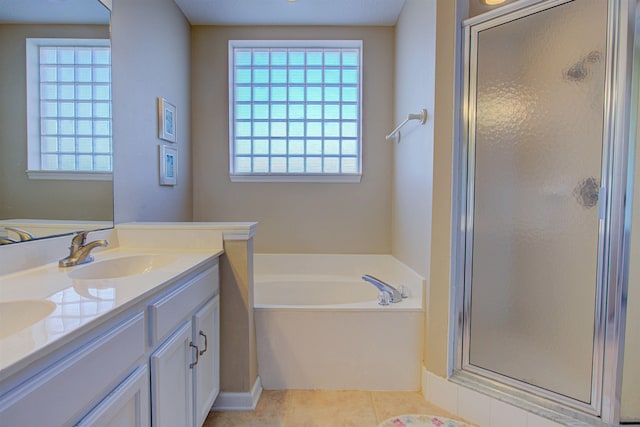 bathroom featuring plus walk in shower, tile patterned floors, and vanity