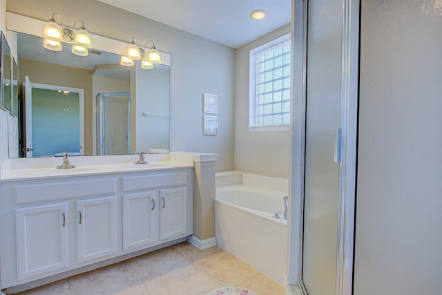 bathroom with tile patterned flooring, separate shower and tub, and vanity