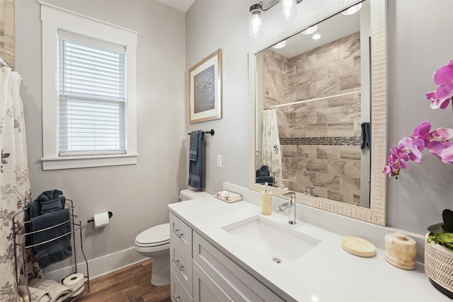 213 Pescado Dr, Saint Augustine, FL 32095 - full bathroom with toilet, wood finished floors, vanity, baseboards, and tiled shower
