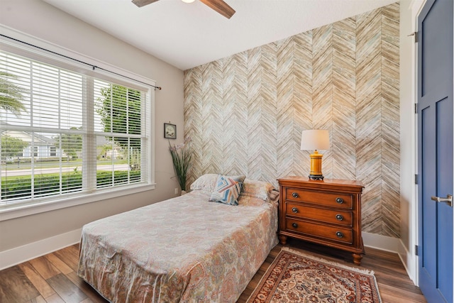 213 Pescado Dr, Saint Augustine, FL 32095 - bedroom with baseboards, an accent wall, wood finished floors, and ceiling fan