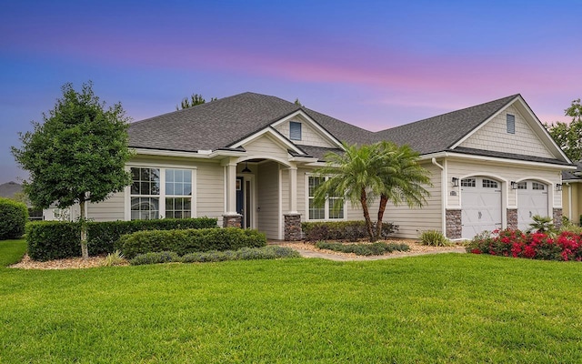 213 Pescado Dr, Saint Augustine, FL 32095 - craftsman house with a lawn, an attached garage, a shingled roof, and stone siding