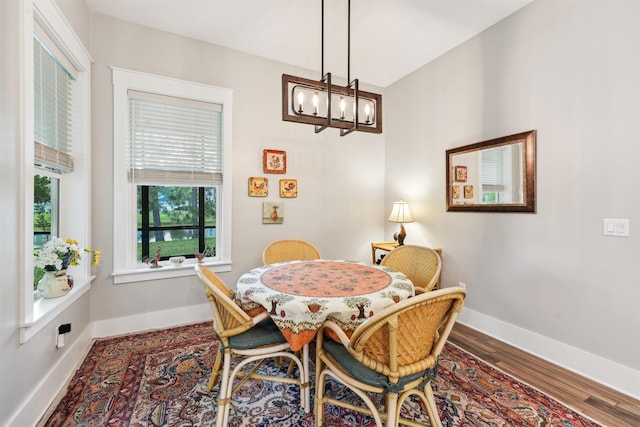 213 Pescado Dr, Saint Augustine, FL 32095 - dining space featuring a chandelier, baseboards, and wood finished floors