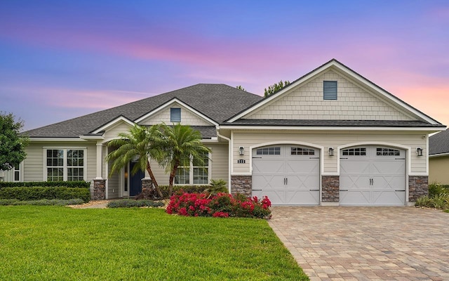 213 Pescado Dr, Saint Augustine, FL 32095 - craftsman inspired home featuring driveway, a garage, a front lawn, stone siding, and a shingled roof