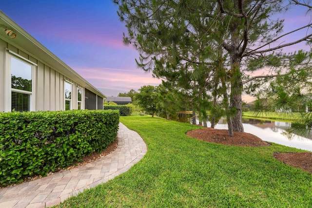 213 Pescado Dr, Saint Augustine, FL 32095 - yard at dusk featuring a yard and a water view