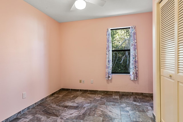 29 Hybiscus Ave, Saint Augustine, FL 32084 - empty room featuring baseboards, dark stone finish flooring, and a ceiling fan