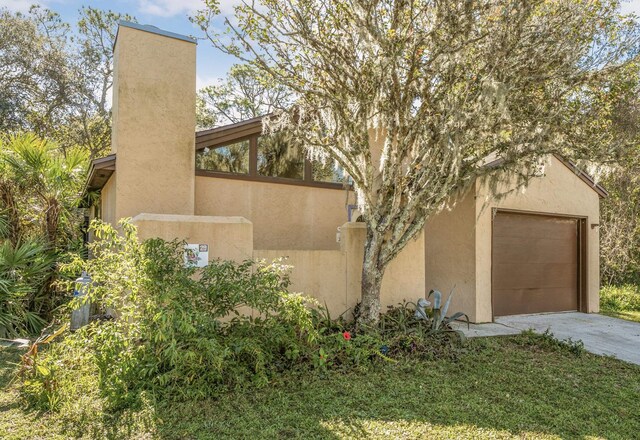 29 Hybiscus Ave, Saint Augustine, FL 32084 - view of home's exterior featuring driveway, a garage, and stucco siding