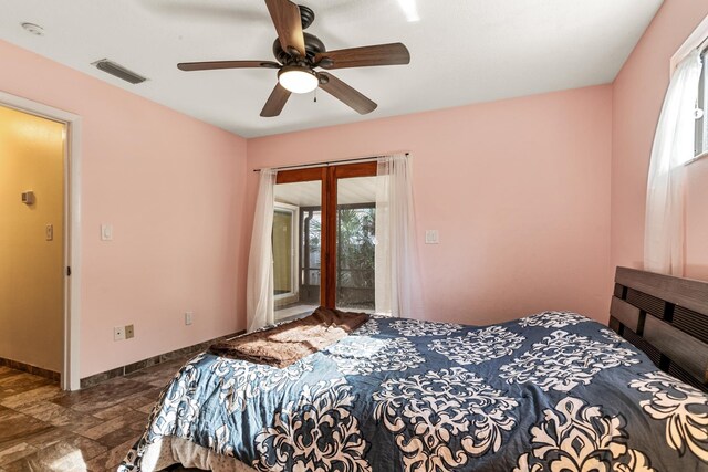 29 Hybiscus Ave, Saint Augustine, FL 32084 - bedroom with multiple windows, access to outside, stone finish floors, and a ceiling fan