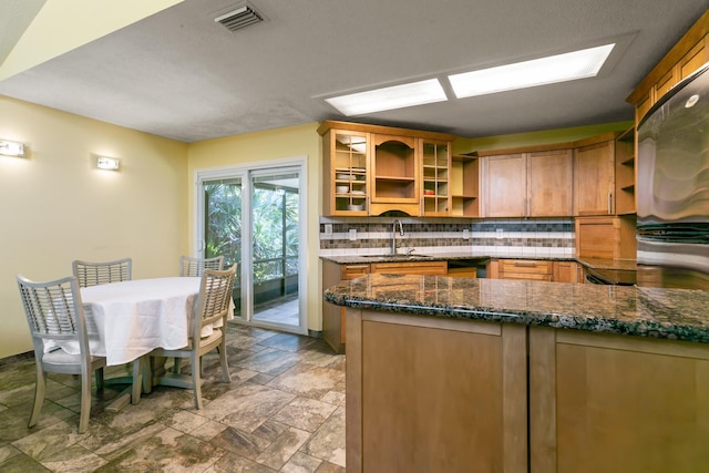 29 Hybiscus Ave, Saint Augustine, FL 32084 - kitchen featuring open shelves, a sink, decorative backsplash, and stone tile flooring