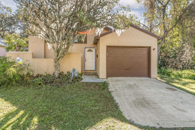 29 Hybiscus Ave, Saint Augustine, FL 32084 - view of front of home with stucco siding, an attached garage, driveway, and a front lawn
