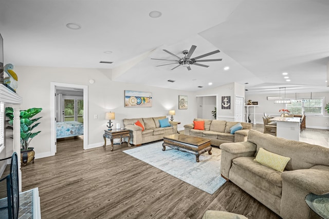 living room with vaulted ceiling, ceiling fan, and dark hardwood / wood-style floors