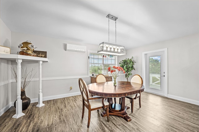 dining room featuring wood-type flooring and a wall mounted air conditioner