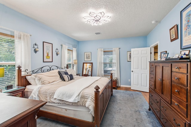 117 Spanish Oaks Ln, Saint Augustine Beach, FL 32080 - bedroom featuring a textured ceiling and wood finished floors