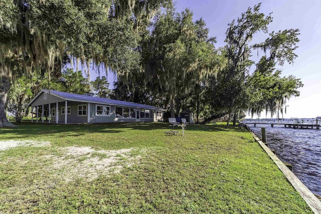 exterior space with a water view and a front yard