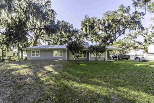 ranch-style home featuring a front yard and a carport