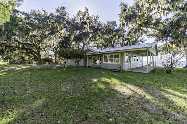 view of front of home with a front yard and a patio area