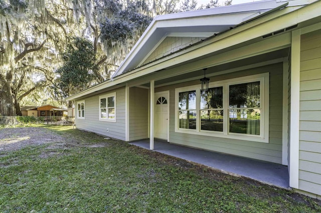 doorway to property with a yard